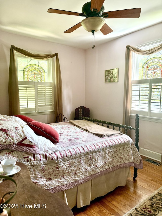 2210 Klein Rd, Wilmington, NC 28405 - bedroom featuring multiple windows, wood finished floors, ceiling fan, and baseboards