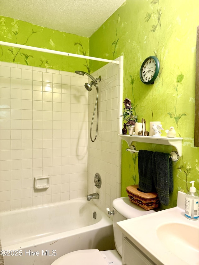 2210 Klein Rd, Wilmington, NC 28405 - full bathroom with wallpapered walls, a textured ceiling, toilet, washtub / shower combination, and vanity