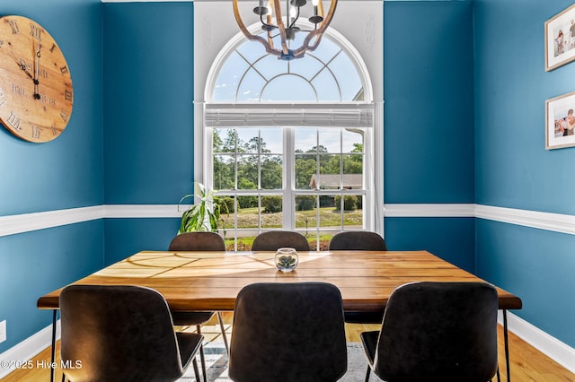1682 Gores Landing Rd SW, Ocean Isle Beach, NC 28469 - dining area featuring baseboards, a chandelier, and wood finished floors