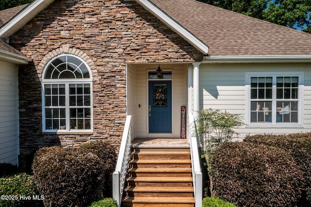 1682 Gores Landing Rd SW, Ocean Isle Beach, NC 28469 - view of exterior entry with stone siding and a shingled roof