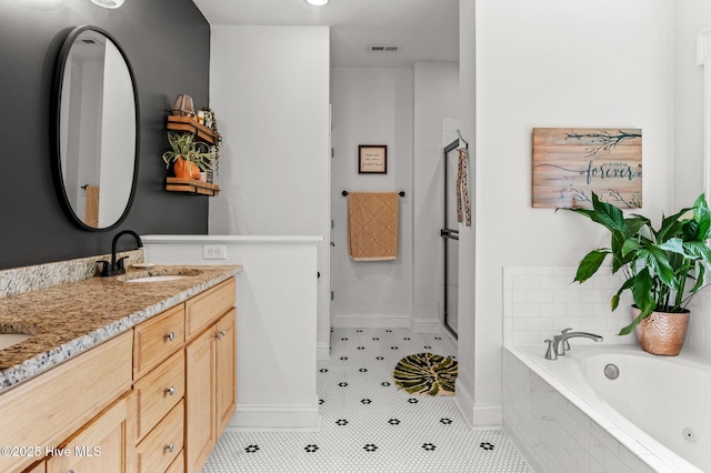 1682 Gores Landing Rd SW, Ocean Isle Beach, NC 28469 - bathroom with double vanity, a whirlpool tub, baseboards, tile patterned flooring, and a shower