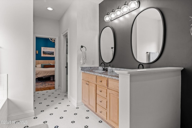 1682 Gores Landing Rd SW, Ocean Isle Beach, NC 28469 - bathroom featuring double vanity, ensuite bathroom, recessed lighting, and baseboards