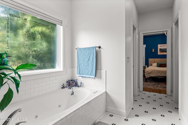 1682 Gores Landing Rd SW, Ocean Isle Beach, NC 28469 - full bath with a whirlpool tub, ensuite bath, baseboards, and healthy amount of natural light