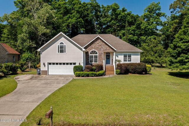 1682 Gores Landing Rd SW, Ocean Isle Beach, NC 28469 - view of front of home with an attached garage, driveway, stone siding, and a front yard