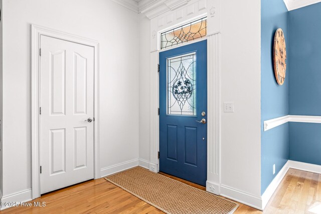 1682 Gores Landing Rd SW, Ocean Isle Beach, NC 28469 - foyer entrance featuring wood finished floors, baseboards, and crown molding