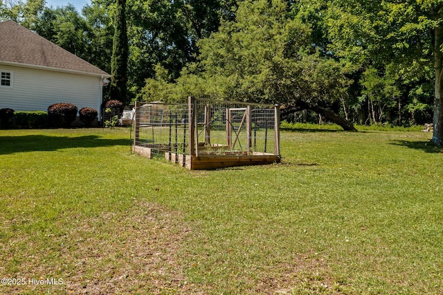 1682 Gores Landing Rd SW, Ocean Isle Beach, NC 28469 - view of green lawn featuring a garden