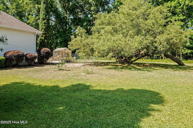 1682 Gores Landing Rd SW, Ocean Isle Beach, NC 28469 - view of grassy yard with a greenhouse and an outbuilding