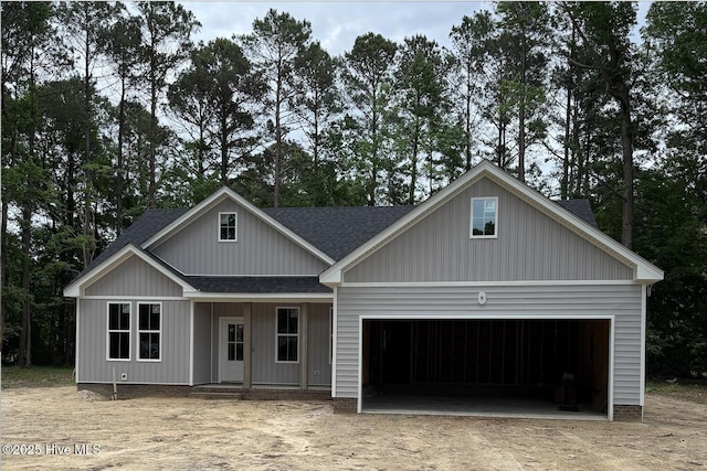 129 Bayview Trl, Edenton, NC 27932 - view of front of home with a shingled roof, dirt driveway, and an attached garage