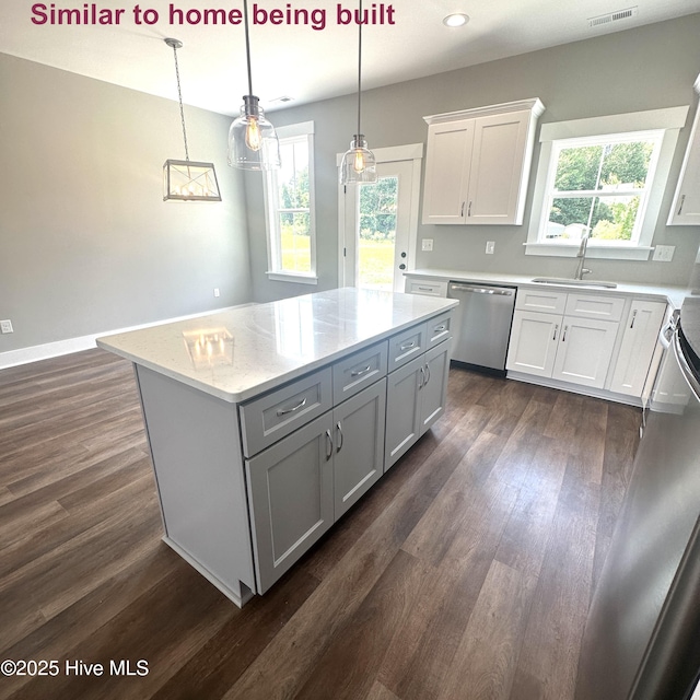 129 Bayview Trl, Edenton, NC 27932 - kitchen with stainless steel dishwasher, a center island, dark wood finished floors, white cabinets, and gray cabinets