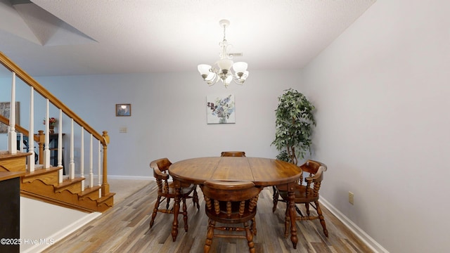 923 Persimmon Pl, Winterville, NC 28590 - dining area featuring a chandelier, light wood-style floors, stairway, and baseboards
