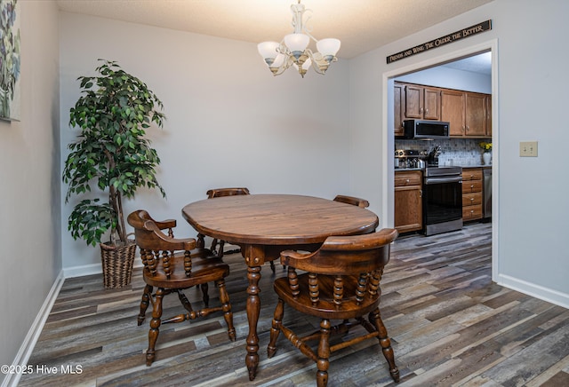 923 Persimmon Pl, Winterville, NC 28590 - dining space with dark wood-style floors, a chandelier, and baseboards