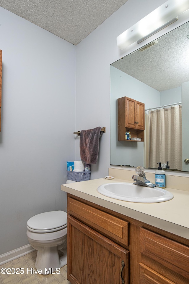 923 Persimmon Pl, Winterville, NC 28590 - bathroom featuring a textured ceiling, vanity, toilet, tile patterned flooring, and curtained shower