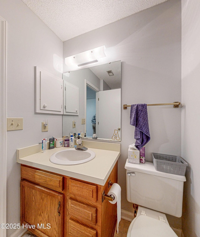 923 Persimmon Pl, Winterville, NC 28590 - bathroom with vanity, toilet, a textured ceiling, and tile patterned floors