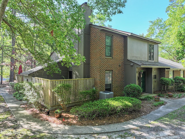 923 Persimmon Pl, Winterville, NC 28590 - view of front of property with brick siding, central AC unit, and a chimney