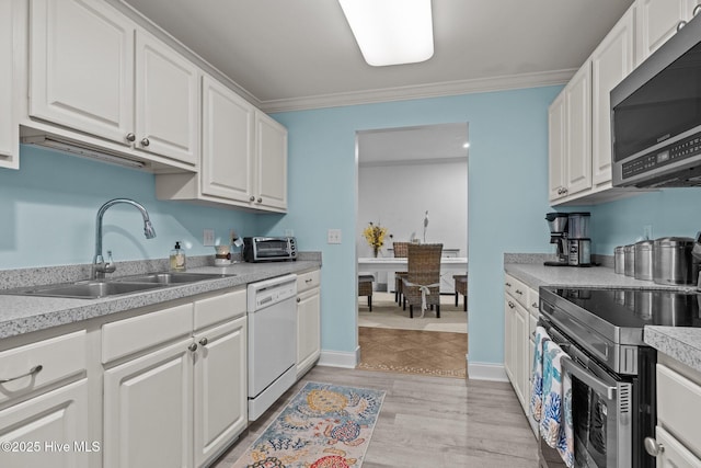 404 Penny Ln Unit F, Morehead City, NC 28557 - kitchen with stainless steel appliances, a sink, ornamental molding, white cabinetry, and light countertops