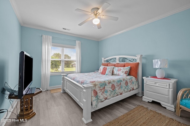404 Penny Ln Unit F, Morehead City, NC 28557 - bedroom with light wood-style flooring, crown molding, baseboards, and a ceiling fan