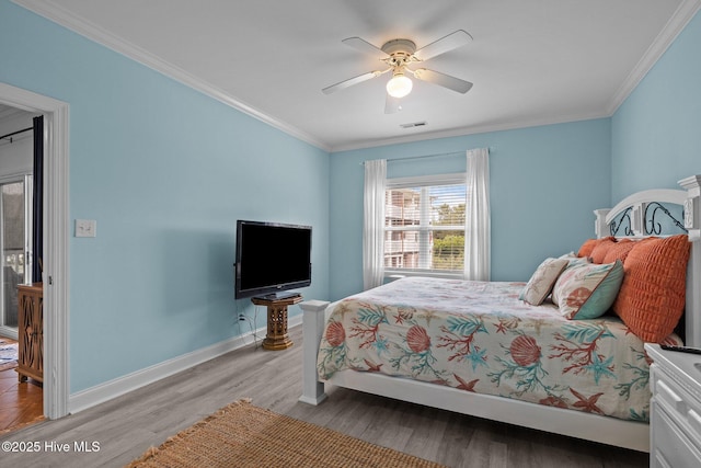 404 Penny Ln Unit F, Morehead City, NC 28557 - bedroom featuring ornamental molding, wood finished floors, baseboards, and ceiling fan