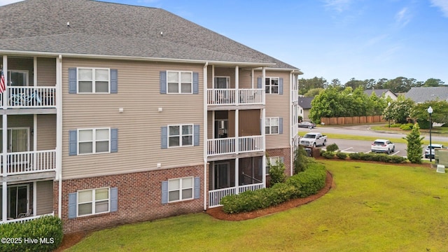 404 Penny Ln Unit F, Morehead City, NC 28557 - rear view of property featuring brick siding and a lawn