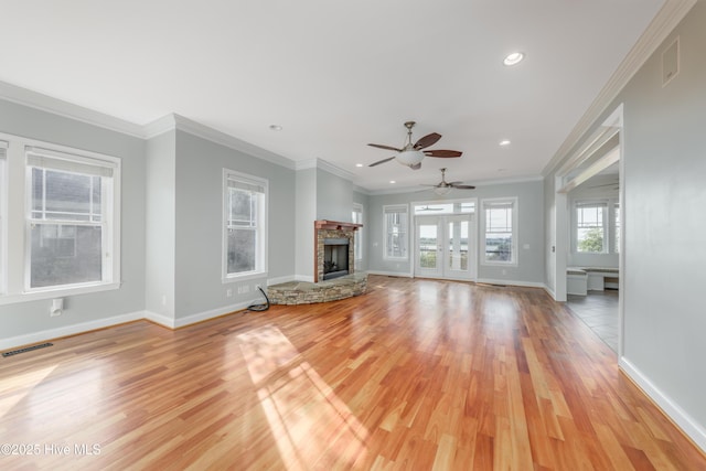 1911 Middle Sound Loop Rd, Wilmington, NC 28411 - unfurnished living room featuring light wood-style flooring, recessed lighting, a ceiling fan, a fireplace, and crown molding