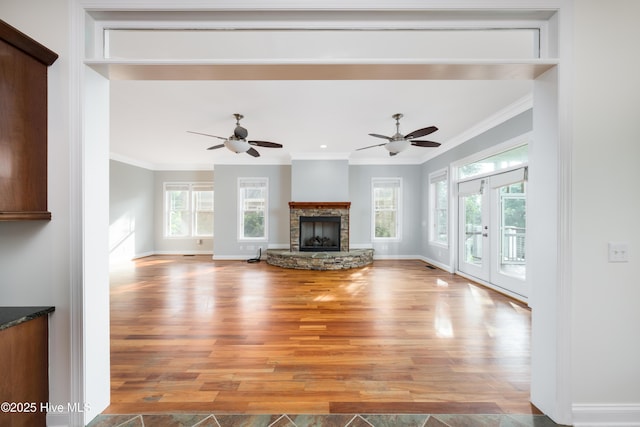 1911 Middle Sound Loop Rd, Wilmington, NC 28411 - unfurnished living room with light wood-style floors, healthy amount of natural light, crown molding, and a ceiling fan