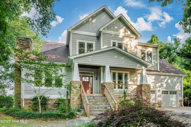 1911 Middle Sound Loop Rd, Wilmington, NC 28411 - craftsman house with board and batten siding, a garage, a porch, stairs, and roof with shingles