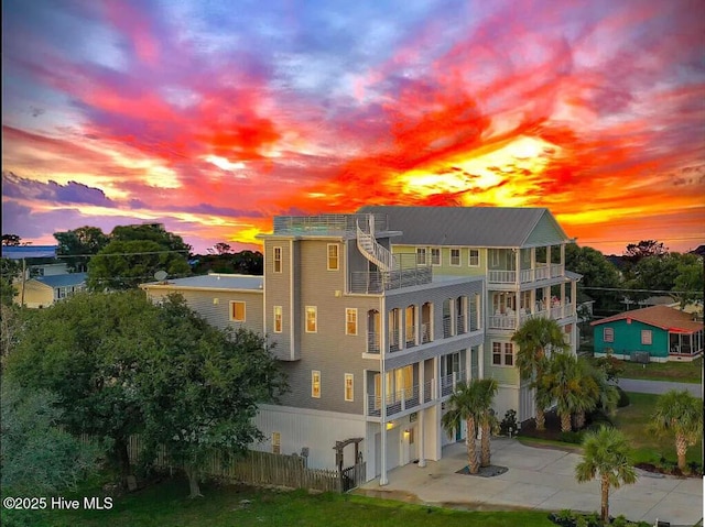 302 Alabama Ave Unit 2, Carolina Beach, NC 28428 - rear view of property with driveway, a balcony, and a garage