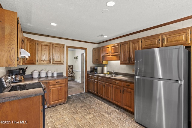 418 Grants Creek Rd, Jacksonville, NC 28546 - kitchen featuring appliances with stainless steel finishes, under cabinet range hood, dark countertops, ornamental molding, and brick patterned floors