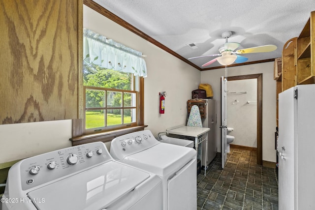 418 Grants Creek Rd, Jacksonville, NC 28546 - laundry room featuring washing machine and clothes dryer, brick patterned floors, ceiling fan, crown molding, and a textured ceiling