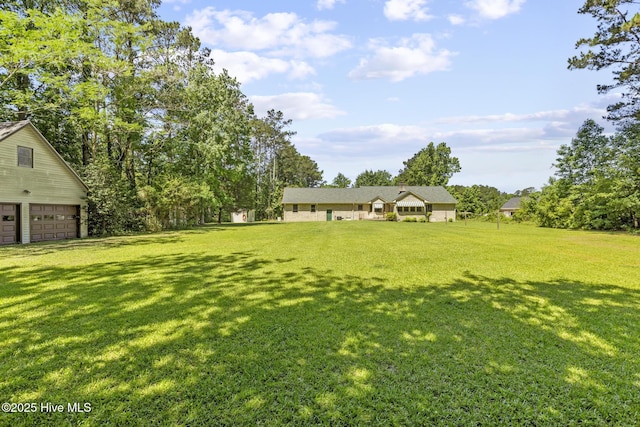 418 Grants Creek Rd, Jacksonville, NC 28546 - view of grassy yard with a garage