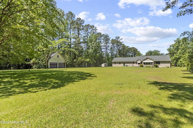 418 Grants Creek Rd, Jacksonville, NC 28546 - view of green lawn with a garage and an outbuilding