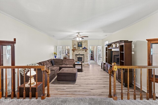 418 Grants Creek Rd, Jacksonville, NC 28546 - living room featuring a fireplace, crown molding, a ceiling fan, wood finished floors, and baseboards