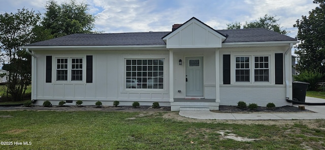 107 Carolina Ave, Clinton, NC 28328 - view of front of home featuring board and batten siding, a front yard, a shingled roof, and brick siding