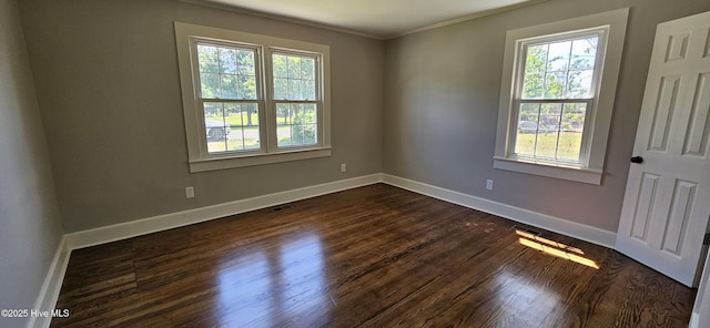 107 Carolina Ave, Clinton, NC 28328 - spare room featuring healthy amount of natural light, crown molding, dark wood-type flooring, and baseboards