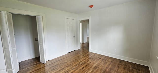107 Carolina Ave, Clinton, NC 28328 - unfurnished bedroom with dark wood finished floors and baseboards