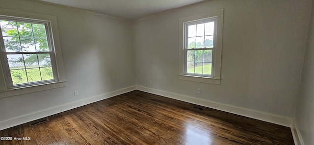 107 Carolina Ave, Clinton, NC 28328 - unfurnished room featuring healthy amount of natural light, crown molding, baseboards, and dark wood finished floors