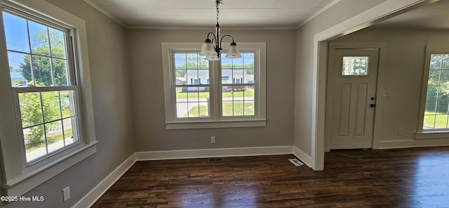 107 Carolina Ave, Clinton, NC 28328 - unfurnished dining area featuring a chandelier, ornamental molding, dark wood-style flooring, and baseboards