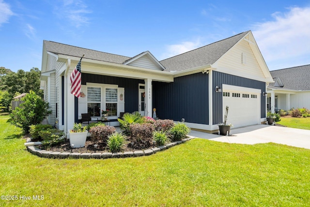 3649 Daufuskie Dr, Wilmington, NC 28412 - view of front of property featuring an attached garage, a front lawn, concrete driveway, and a porch