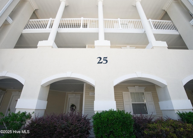 1215 N Middleton Dr NW Apt 2505, Calabash, NC 28467 - view of exterior entry featuring stucco siding and a balcony