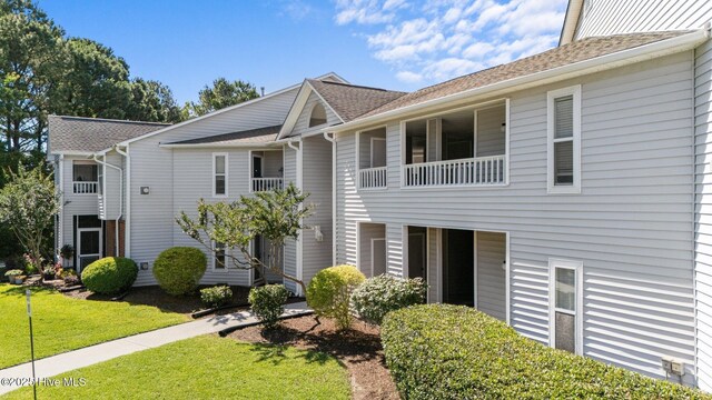 4109 Breezewood Dr Unit 204, Wilmington, NC 28412 - view of property featuring a front lawn and roof with shingles