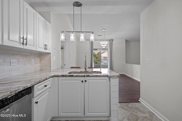 4109 Breezewood Dr Unit 204, Wilmington, NC 28412 - kitchen with a sink, stainless steel dishwasher, a peninsula, white cabinetry, and tasteful backsplash