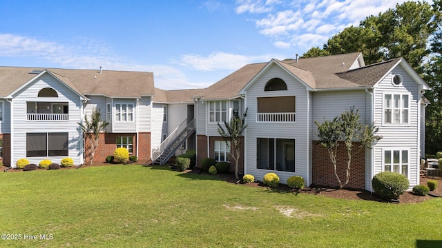 4109 Breezewood Dr Unit 204, Wilmington, NC 28412 - townhome / multi-family property featuring a front lawn, brick siding, and stairway