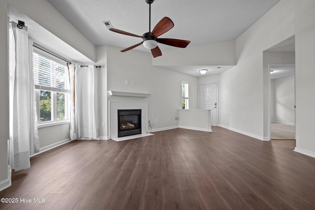 4109 Breezewood Dr Unit 204, Wilmington, NC 28412 - unfurnished living room with ceiling fan, a fireplace with flush hearth, dark wood-type flooring, baseboards, and a textured ceiling