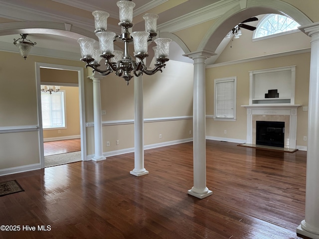 315 Hunters Creek Dr, Goldsboro, NC 27534 - unfurnished living room featuring healthy amount of natural light, a fireplace with flush hearth, a chandelier, a ceiling fan, and crown molding