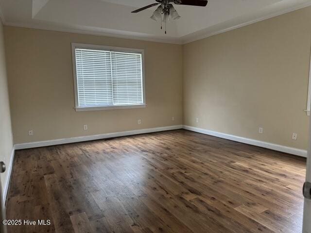 315 Hunters Creek Dr, Goldsboro, NC 27534 - unfurnished room with a ceiling fan, ornamental molding, dark wood finished floors, baseboards, and a raised ceiling