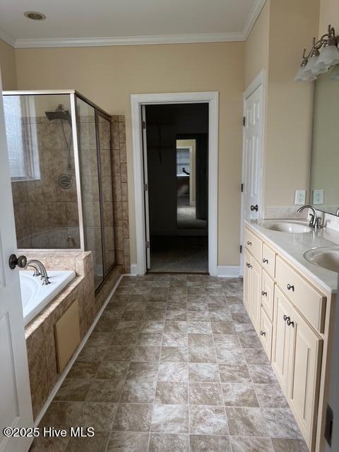 315 Hunters Creek Dr, Goldsboro, NC 27534 - bathroom with a shower stall, a bath, double vanity, ornamental molding, and baseboards