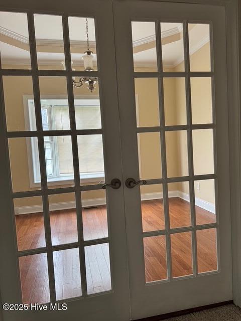 315 Hunters Creek Dr, Goldsboro, NC 27534 - detailed view of french doors, baseboards, wood finished floors, and crown molding