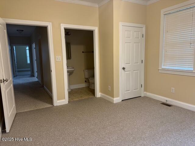 315 Hunters Creek Dr, Goldsboro, NC 27534 - unfurnished bedroom with crown molding, carpet, baseboards, and ensuite bathroom