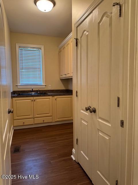 315 Hunters Creek Dr, Goldsboro, NC 27534 - laundry room with a sink, dark wood-type flooring, and baseboards