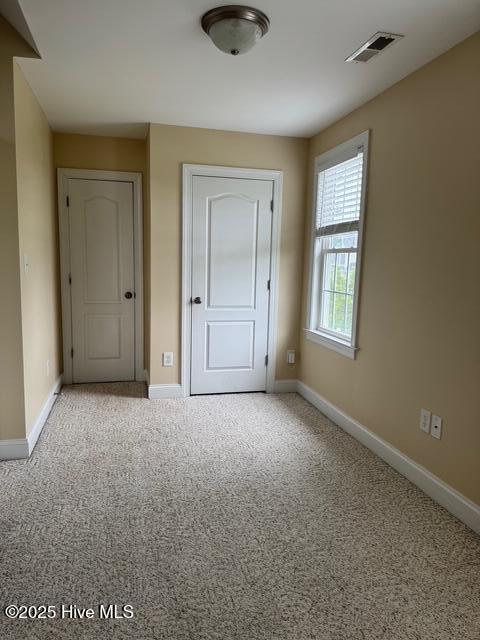 315 Hunters Creek Dr, Goldsboro, NC 27534 - unfurnished bedroom with baseboards, carpet floors, and a closet