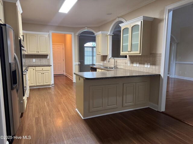 315 Hunters Creek Dr, Goldsboro, NC 27534 - kitchen with a sink, stainless steel refrigerator with ice dispenser, wood finished floors, a peninsula, and ornamental molding